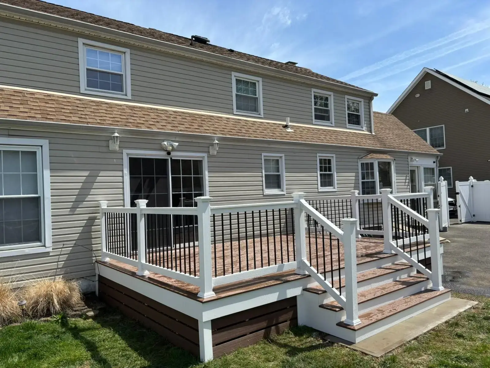 Wraparound composite deck with white railing in Bergen County, NJ